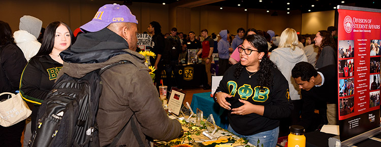 Student talking with other students during a fair event.
